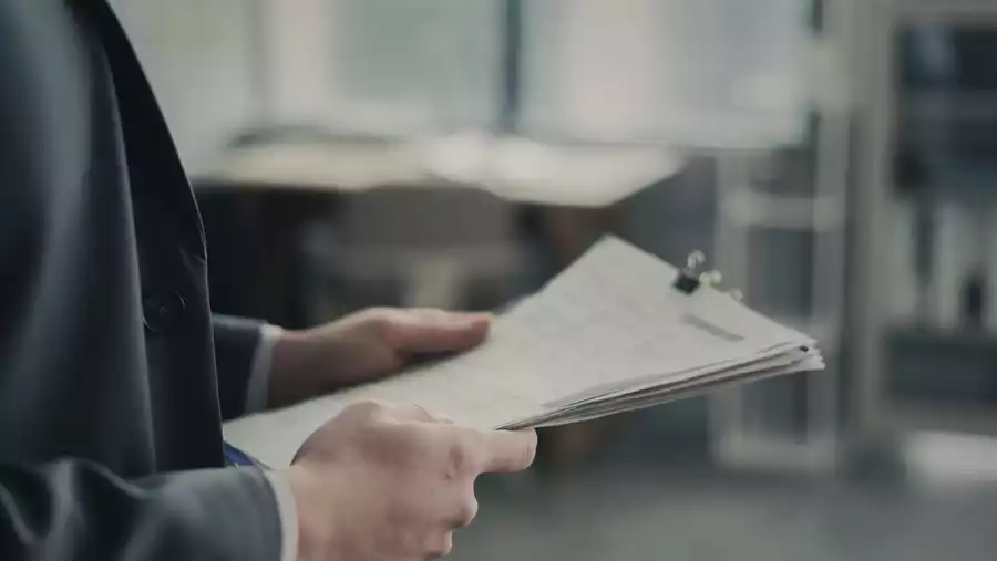 A businessman with documents in his hands.