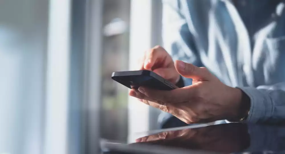 A business owner using a smartphone.